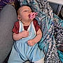 Sabrina is registered to the contest to win money with this photo: baby, pacifier, blanket, blue_outfit, sleeping, infant, soft_texture, patterned_blanket, resting, cute, child, clothing, comfort, indoor, person, newborn, hand, face, head, relaxation