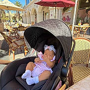 Serena joined the competition — help win amazing prizes! baby, stroller, outdoor, cafe, umbrella, child, infant, sunlight, table, chair, building, window, footwear, headband, relaxing, shade, people, daylight, person, fashion