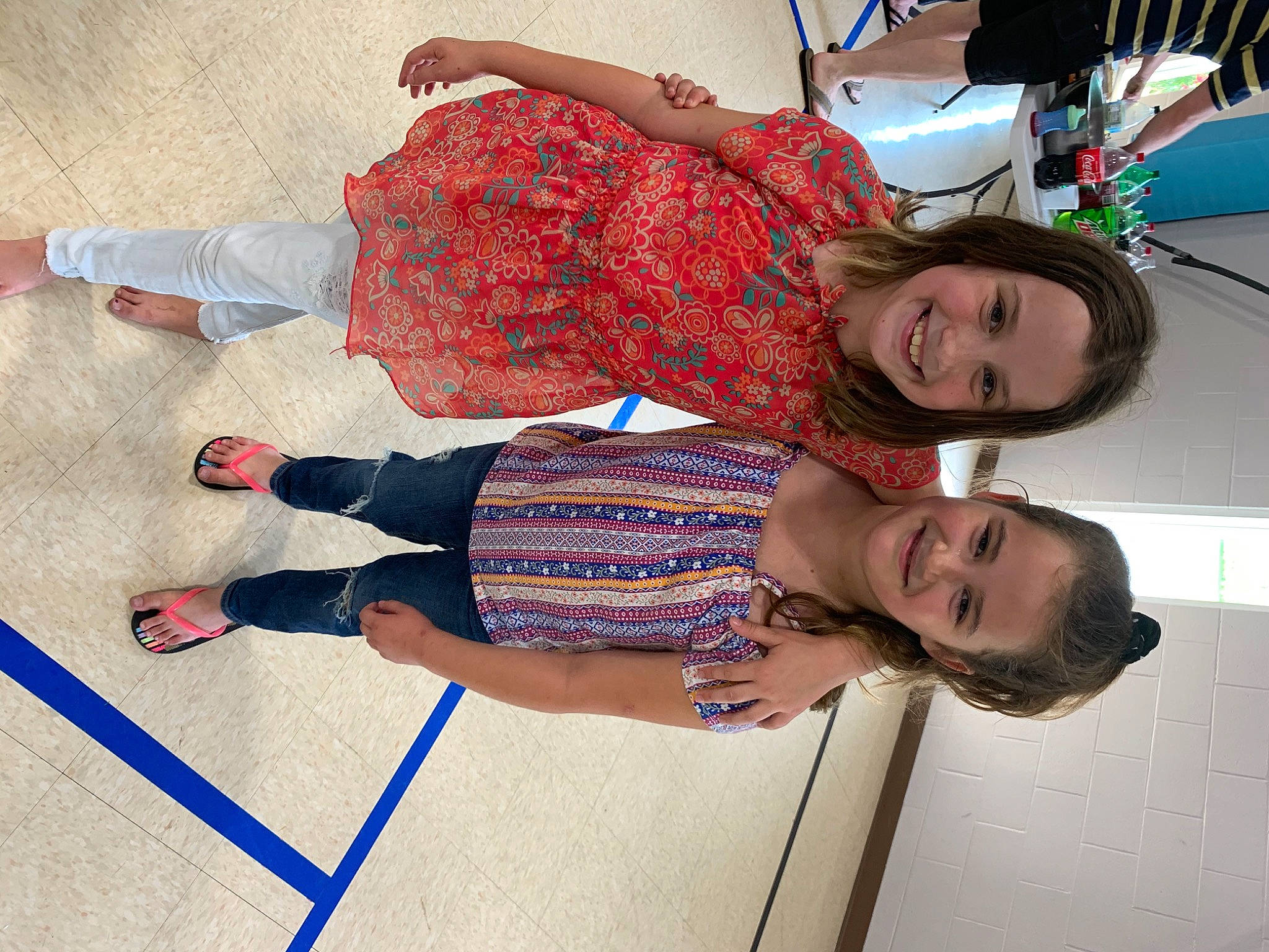 Erin is registered to the contest to win money with this photo: child, comfort, cool, flooring, fun, happy, hat, human_leg, joint, joy, knee, leg, leisure, pattern, person, smile, t_shirt, thigh, toddler, travel