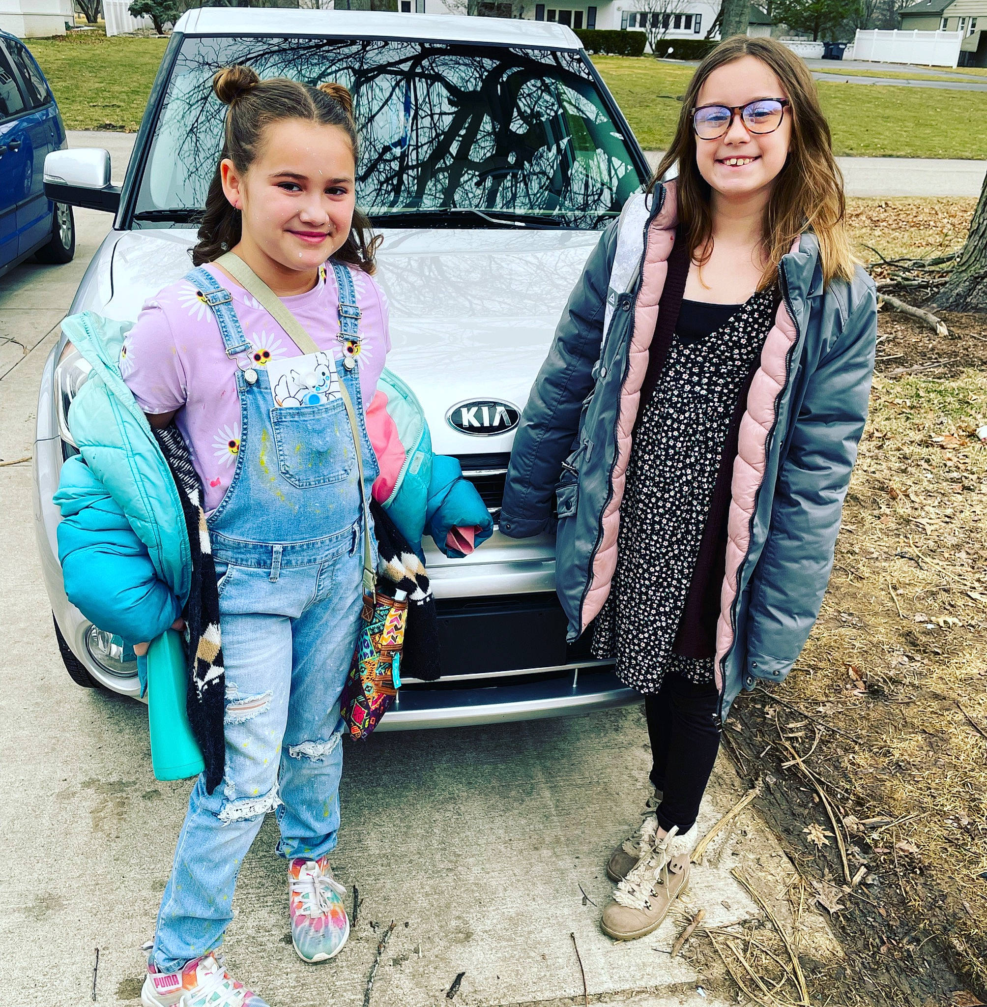 Victoria is registered to the contest to win money with this photo: automotive_design, automotive_lighting, bumper, car, clothing, eyewear, facial_expression, footwear, glasses, hairstyle, joy, land_vehicle, motor_vehicle, person, shoe, smile, street_fashion, style, textile, tire