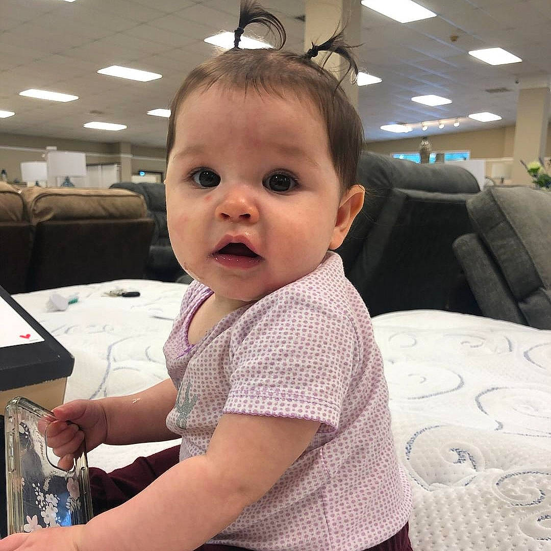 Astrid is registered to the contest to win money with this photo: audio_equipment, automotive_design, baby, baby_toddler_clothing, chair, cheek, child, comfort, computer_keyboard, eyelash, flooring, fun, hairstyle, happy, mammal, office_equipment, person, room, sitting, surprise