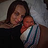 Karma is registered to the contest to win money with this photo: woman, baby, newborn, portrait, face, smile, bed, blanket, striped_blanket, pillow, indoor, family, love, mother, child, skin, head, resting, closeup, comfort