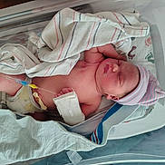 Karma joined the competition — help win amazing prizes! newborn, baby, hospital, bassinet, blanket, diaper, hat, medical_tube, infant, sleeping, skin, person, healthcare, nursery, bed, hospital_bed, cute, wrapped, resting, pink