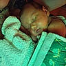 Karma is registered to the contest to win money with this photo: baby, sleeping, blanket, towel, child, face, person, closeup, cozy, indoor, resting, infant, comfort, soft, warm, peaceful, human, portrait, cuddle, nap