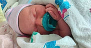 Karma is registered to the contest to win money with this photo: newborn, baby, pacifier, blanket, hospital, sleeping, cap, infant, wrapped, cute, peaceful, hand, skin, face, closeup, bed, comfort, child, hospital_bed, baby_clothes