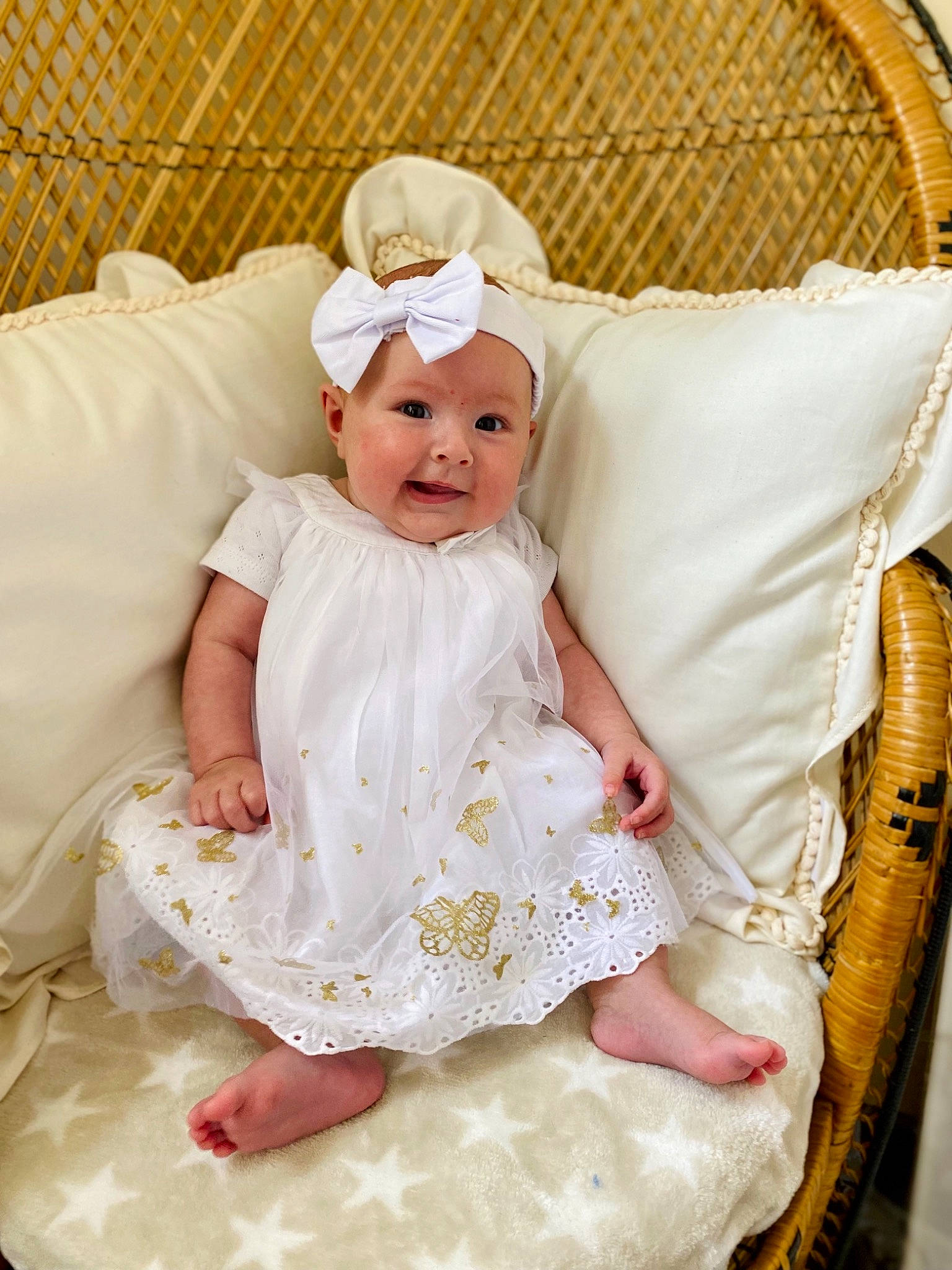 Diane participe au concours pour gagner de l'argent avec cette photo : baby, baby_toddler_clothing, bridal_accessory, chair, child, comfort, dress, embellishment, event, face, fashion_accessory, happy, headgear, headpiece, headwear, peach, person, skin, sleeve, textile