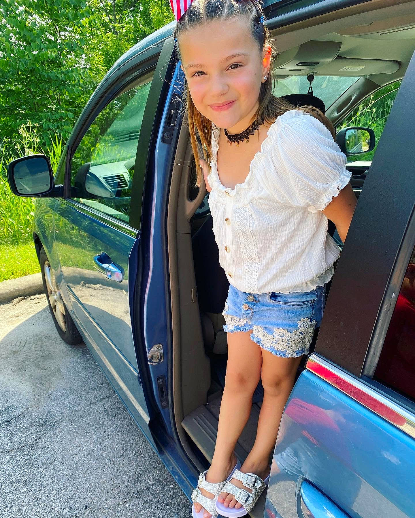 Maddison is registered to the contest to win money with this photo: automotive_design, automotive_exterior, automotive_lighting, blue, bumper, car, eyewear, hood, joy, motor_vehicle, person, personal_luxury_car, plant, shorts, shoulder, sneakers, thigh, trunk, vehicle, vehicle_door