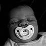 baby, pacifier, sleeping, closeup, black_and_white, infant, face, soft_clothing, peaceful, child, newborn, portrait, cute, resting, head, skin, mouth, nose, eyelids, babywear