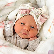 Adelynn is registered to the contest to win money with this photo: baby, blanket, bow, child, clothing, cozy, cute, face, floral, hand, headband, indoors, infant, newborn, portrait, resting, skin, sleepwear, soft, wrapped