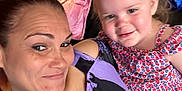 Charli is registered to the contest to win money with this photo: blanket, casual, child, clothing, face, family, furniture, hair, happy, home, indoor, person, ponytail, portrait, selfie, skin, smile, toddler, woman, young_child