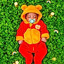 baby, sleeping, onesie, bear_ears, pacifier, clover, greenery, coins, rainbow, cute, infant, outdoor, nature, soft_clothing, peaceful, lying_down, plush, colorful, adorable, child