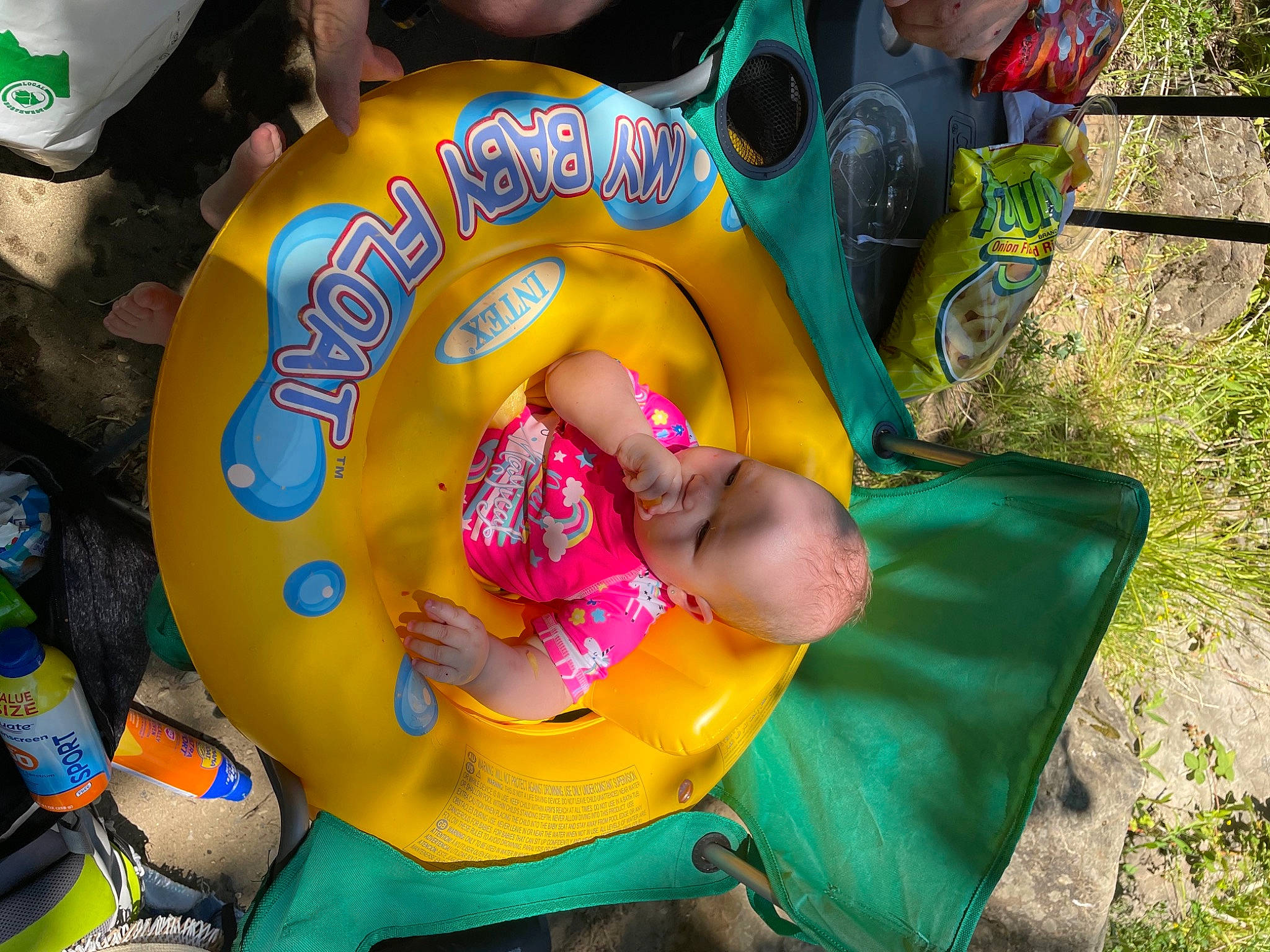 Alaska is registered to the contest to win money with this photo: baby, baby_products, baby_toddler_clothing, chair, child, event, fun, grass, green, happy, hat, lap, leisure, person, plant, play, recreation, shorts, toddler, toy