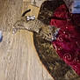 cat, christmas_tree_skirt, cozy, cute, decor, domestic_cat, feline, festive, gift_wrap, holiday, holiday_decor, indoor, kitten, pet, playful, relaxed, silver_bow, small_animal, striped_fur, wooden_floor
