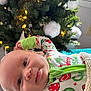 baby, infant, christmas_tree, holiday, pajamas, blanket, face, smile, indoors, decorations, lights, festive, cozy, child, portrait, christmas, warm, happy, cute, celebration
