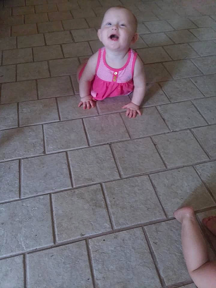 Journea is registered to the contest to win money with this photo: baby, child, crawling, finger, floor, flooring, hand, leg, person, pink, play, tile, toddler