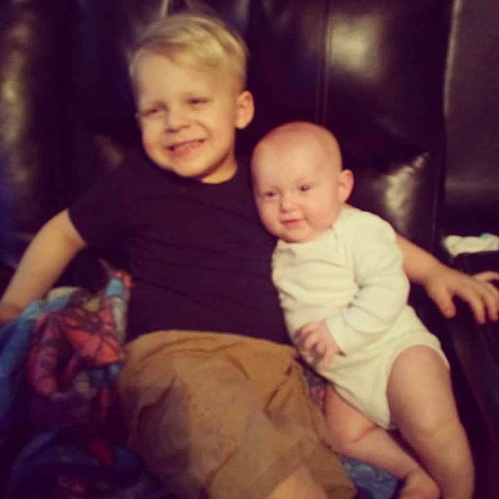 Parker is registered to the contest to win money with this photo: baby, cheek, child, cloud, eye, face, facial_expression, fun, head, human, interaction, iris, joy, lap, leg, people, person, sitting, skin, sky