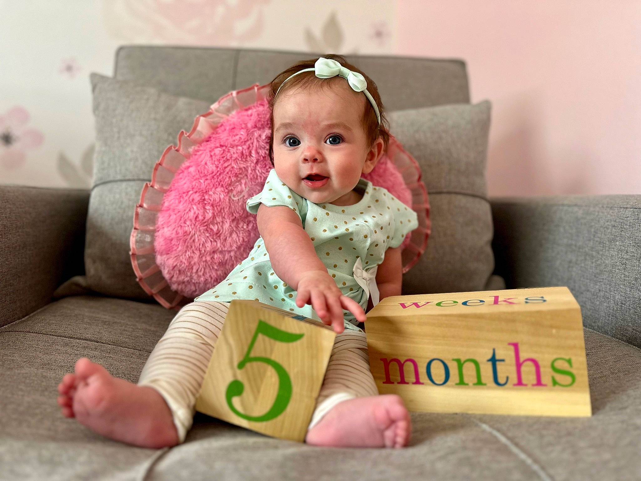 Allison is registered to the contest to win money with this photo: baby, baby_toddler_clothing, beauty, cheek, child, comfort, couch, flash_photography, furniture, happy, people, person, pink, room, sitting, skin, sleeve, smile, throw_pillow, toddler