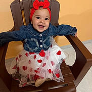 Emily joined the competition — help win amazing prizes! accessory, baby, bow, child, cute, denim_jacket, fashion, happy, hearts, indoor, orange_wall, plastic_chair, portrait, red_headband, shoe, sitting, smile, tile_floor, toddler, tulle_skirt
