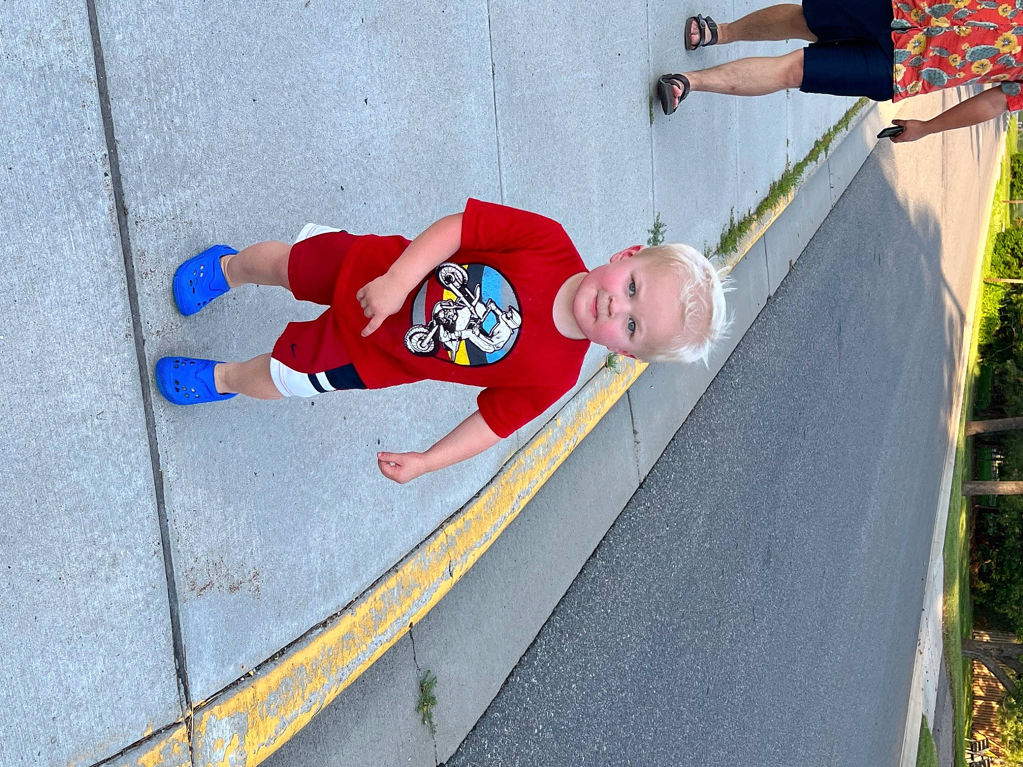 Nikolai is registered to the contest to win money with this photo: asphalt, carmine, child, concrete, electric_blue, fictional_character, fun, leisure, person, plant, recreation, sidewalk, slope, smile, sneakers, sports, sportswear, toddler, tree, walking_shoe
