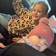 Valentina participe au concours pour gagner de l'argent avec cette photo : child, baby, car, hat, pink_hat, leopard_print, sweater, smiling, curious, seat, sunlight, window, vehicle_interior, portrait, happy, casual_clothing, cute, pom_pom, blond_hair, face