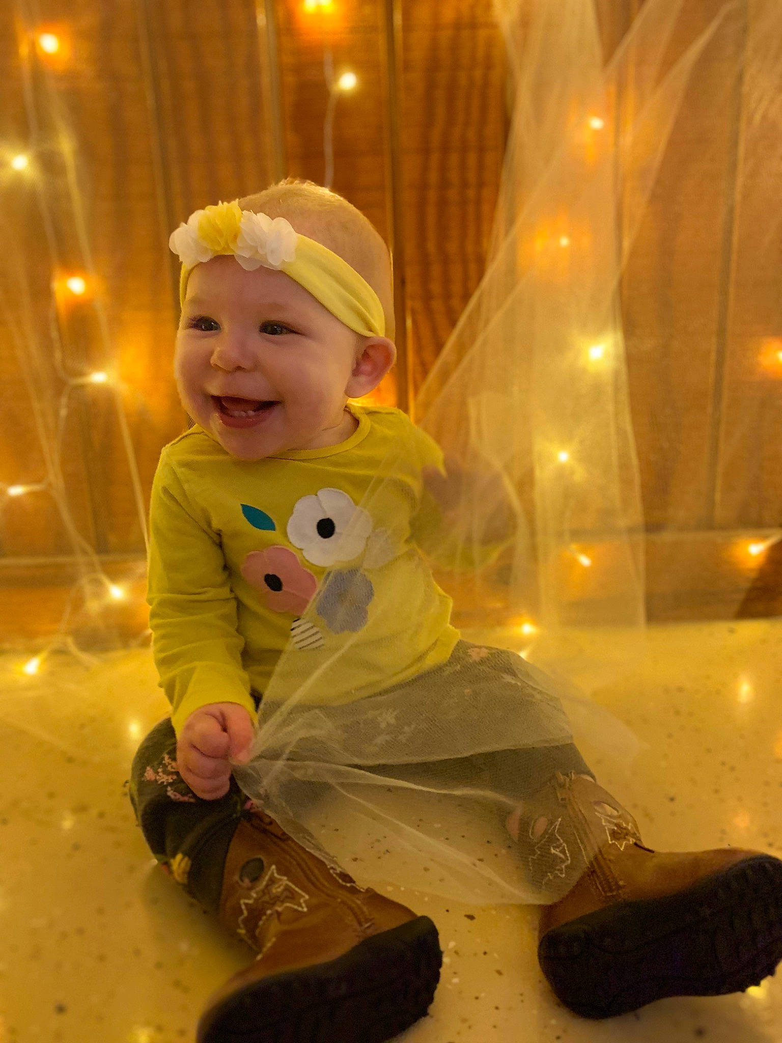Isabell is registered to the contest to win money with this photo: baby, baby_laughing, baby_toddler_clothing, carmine, child, christmas, costume_hat, event, fictional_character, flooring, fun, glass, happy, headwear, holiday, joy, lighting, person, personal_protective_equipment, sitting
