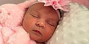 Millie is registered to the contest to win money with this photo: baby, newborn, sleeping, pink_flower, headband, blanket, soft_texture, pillow, closeup, face, peaceful, child, infant, cozy, resting, indoor, portrait, cute, sleep, skin