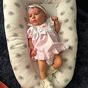 Millie joined the competition — help win amazing prizes! baby, infant, dress, headband, white_bows, cushion, elephant_pattern, footwear, booties, pink, polka_dot, socks, carpet, cute, child, portrait, relaxing, indoors, soft_lighting, baby_girl