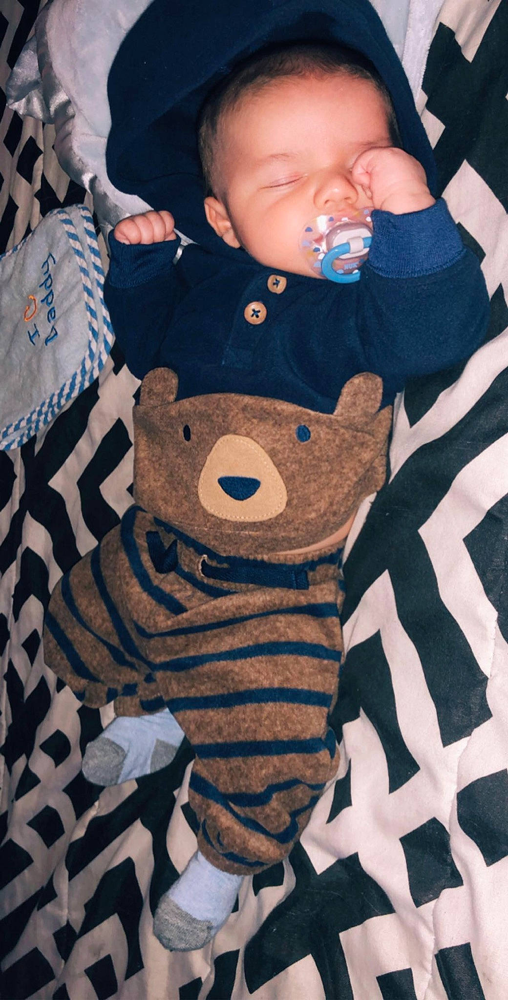 Jaxston is registered to the contest to win money with this photo: baby, baby_products, baby_toys, bear, blanket, blue, brown, cheek, child, linens, person, product, sleep, stuffed_toy, teddy_bear, textile, toddler, toy