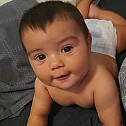 Luke is registered to the contest to win money with this photo: baby, bed, blanket, child, closeup, crawling, curious, cute, diaper, expression, eyes, face, happy, head, indoors, infant, person, skin, smile, young