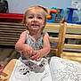 art, cartoon, chair, child, clothing, coloring_book, cute, drawing, education, hair, happy, indoor, person, playful, pony_tail, preschool, smiling, table, toddler, wooden_chair