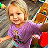 Gracelynn joined the competition — help win amazing prizes! child, blonde_hair, purple_shirt, smiling, indoor, playroom, wooden_furniture, toy, flooring, happy, person, toddler, casual_clothing, cute, young_child, portrait, home, expression, colorful, reaching_out