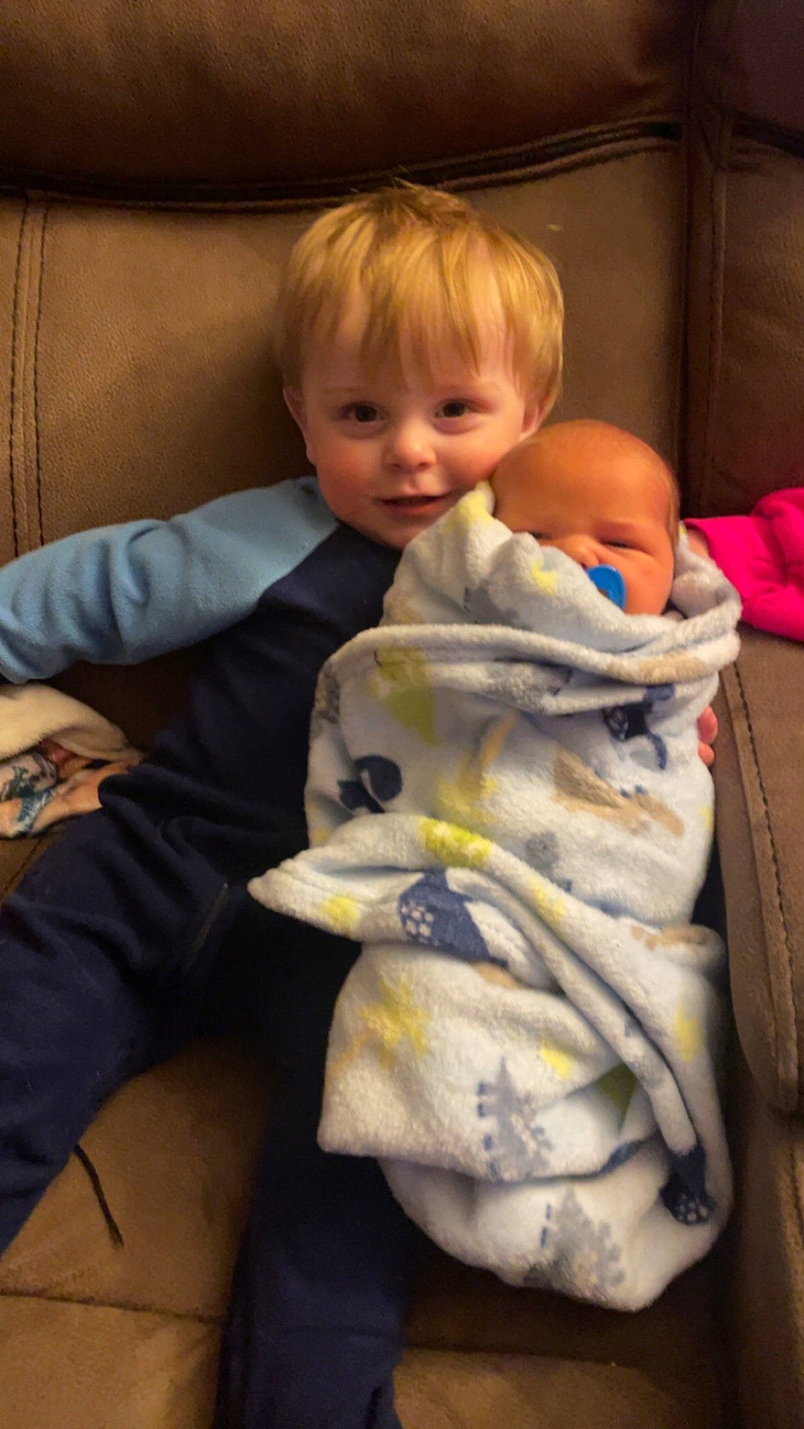 Ryder is registered to the contest to win money with this photo: baby, baby_products, baby_toddler_clothing, blond, cheek, child, comfort, couch, face, head, lap, linens, person, room, sitting, skin, sleeve, smile, toddler
