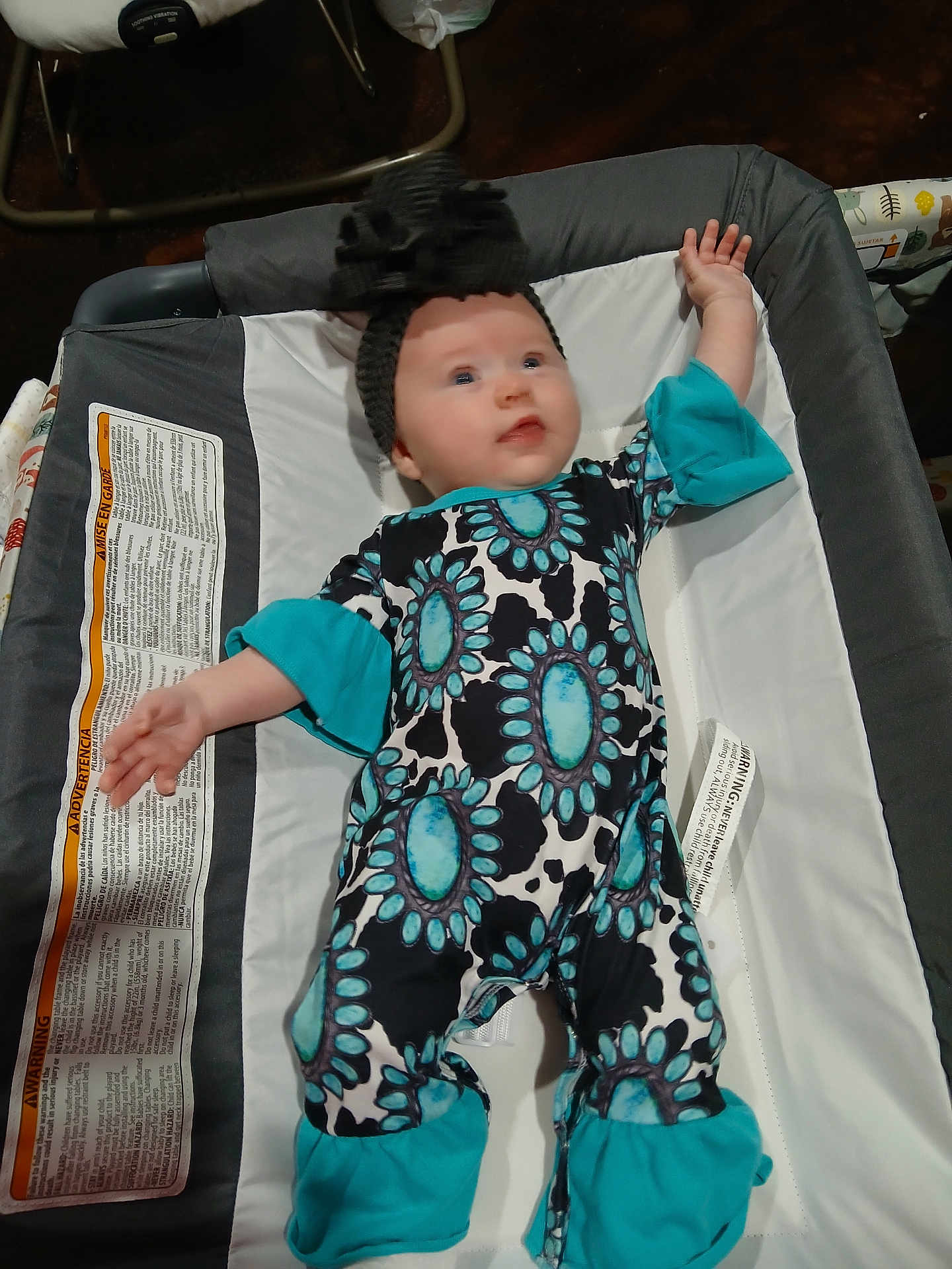 Oakley joined the competition — help win amazing prizes! baby, infant, onesie, headband, baby_carrier, patterned_clothing, blue, black, white, warning_label, padded_surface, stretching, cute, child, indoor, newborn, lying_down, clothing, fabric, person