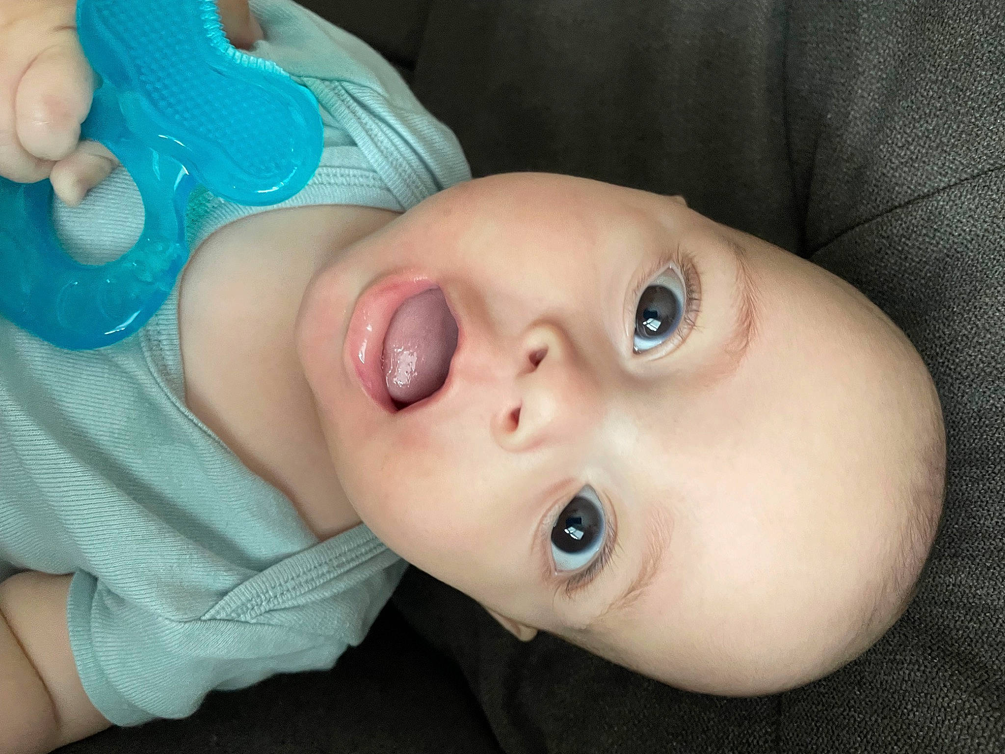 Leland is registered to the contest to win money with this photo: baby, baby_toddler_clothing, cheek, child, close_up, eyelash, gesture, happy, headgear, human_body, iris, lip, mouth, nail, neck, no_expression, nose, person, skin, thumb