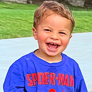 Nova is registered to the contest to win money with this photo: child, toddler, smiling, happy, outdoor, grass, shirt, clothing, blue, spiderman, face, person, laughing, casual, daylight, cute, young, portrait, fun, joyful