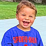 child, toddler, smiling, happy, outdoor, grass, shirt, clothing, blue, spiderman, face, person, laughing, casual, daylight, cute, young, portrait, fun, joyful