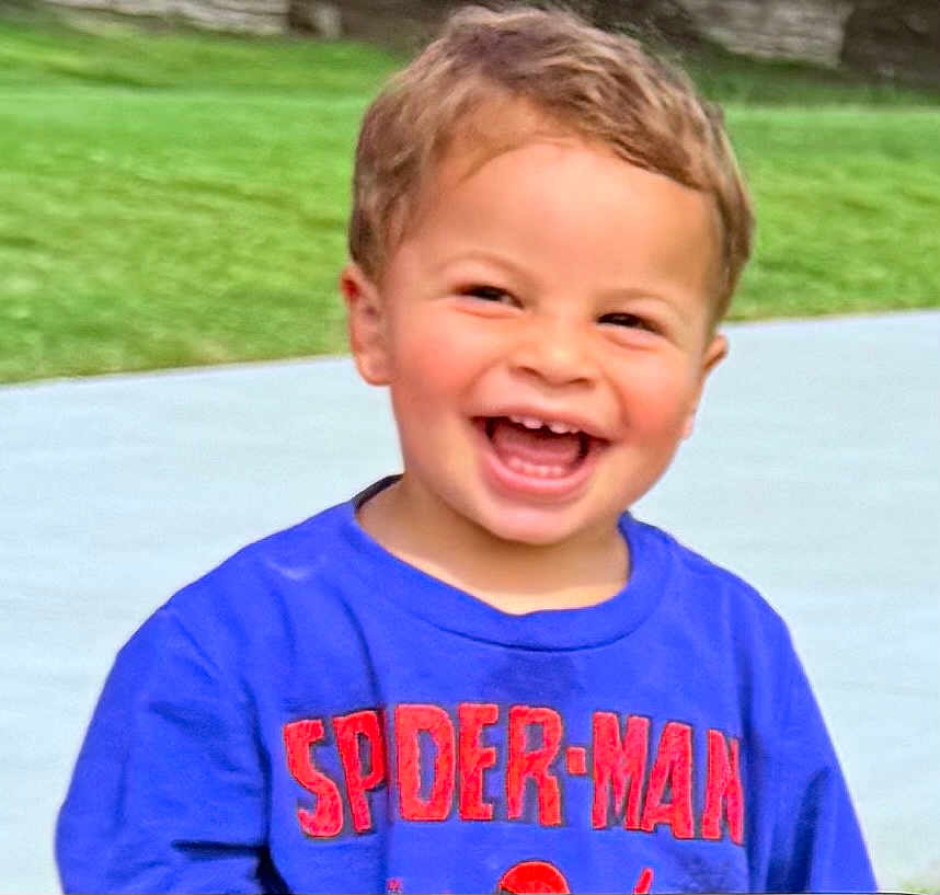 Nova is registered to the contest to win money with this photo: child, toddler, smiling, happy, outdoor, grass, shirt, clothing, blue, spiderman, face, person, laughing, casual, daylight, cute, young, portrait, fun, joyful
