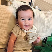 Arlo joined the competition — help win amazing prizes! baby, infant, smiling, plush_toy, couch, wooden_plaque, five_months, child, indoor, cozy, cute, happy, person, cream_color, clothing, portrait, sitting, face, home, soft_texture