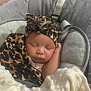 Saniah joined the competition — help win amazing prizes! baby, sleeping, infant, leopard_print, headwrap, blanket, baby_seat, gray, soft, cozy, child, indoors, peaceful, resting, cute, newborn, portrait, warm, comfort, toddler