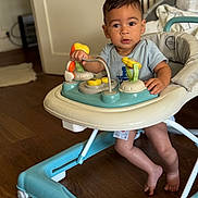 Temeio a rejoint le concours — aidez-le/la à gagner de superbes lots ! baby, baby_walker, barefoot, child, clothing, curious, face, floor, furniture, hands, home, indoor, infant, person, playtime, seat, toddler, toy, wooden_floor, young_child