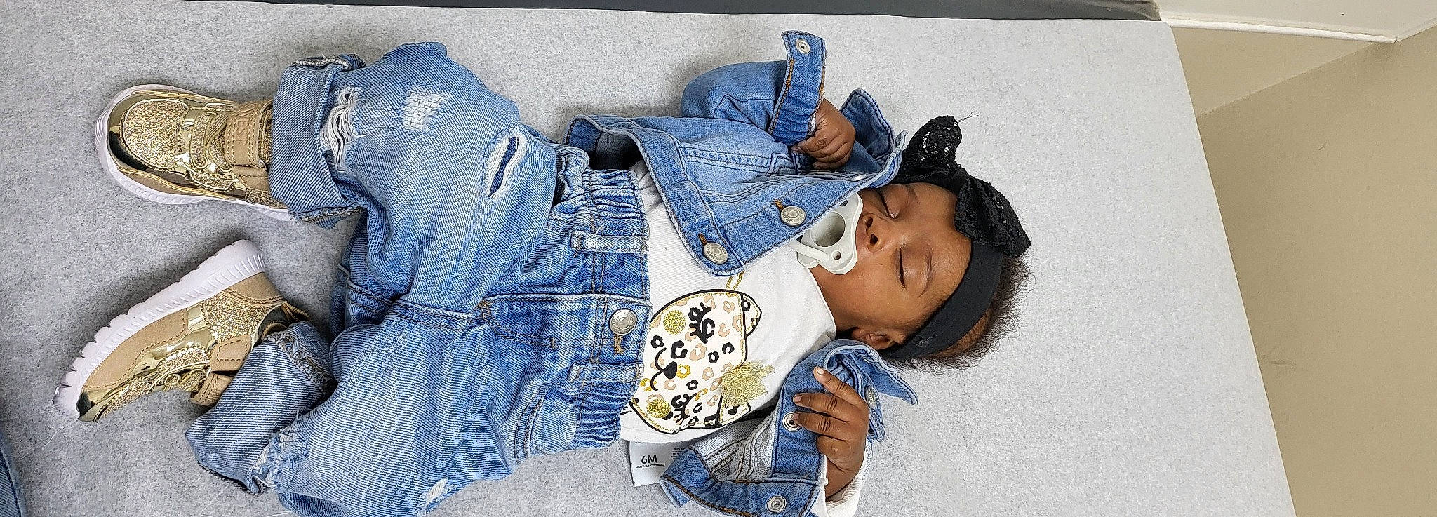 Kassidy is registered to the contest to win money with this photo: arm, baby_toddler_clothing, child, comfort, couch, denim, electric_blue, eye, fashion_accessory, happy, jeans, linens, pattern, person, pocket, sitting, sleeve, t_shirt, textile, thigh