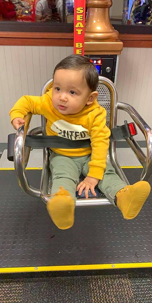 Josue is registered to the contest to win money with this photo: chair, child, person, play, sitting, smile, toddler, yellow