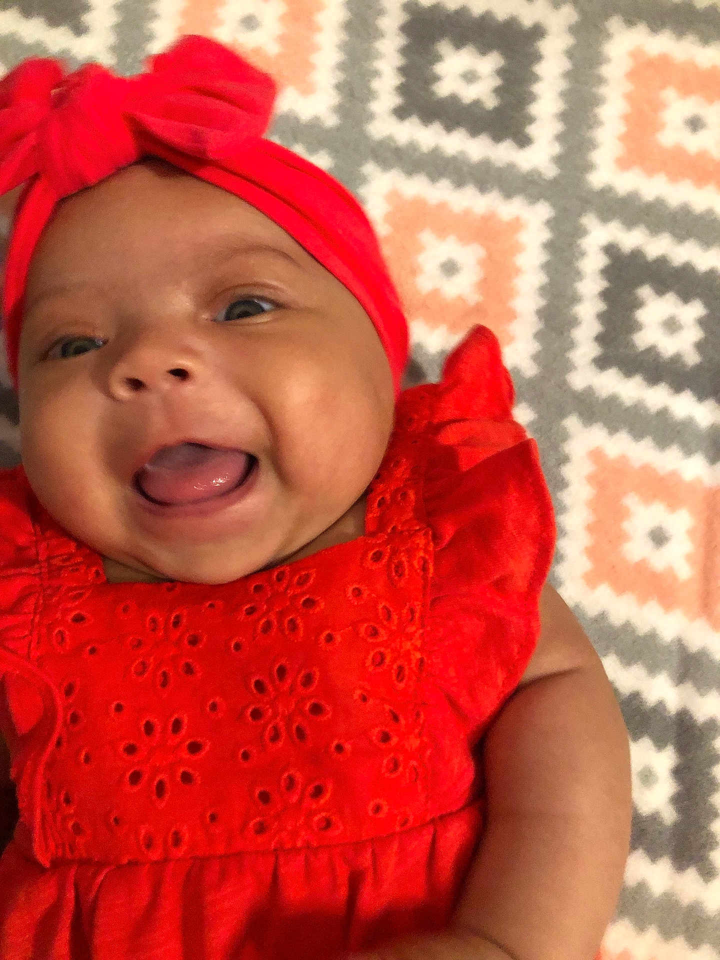Paizlie joined the competition — help win amazing prizes! baby, baby_girl, bright_colors, cheerful, child, close_up, cute, fabric, face, happy, headband, infant, lying_down, orange_clothing, patterned_blanket, portrait, smiling, soft_skin, tongue_out, young