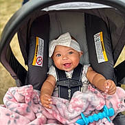 Paizlie joined the competition — help win amazing prizes! baby, smiling, stroller, blanket, toy, headband, child, happy, infant, seatbelt, outdoor, cute, face, person, clothing, pink, blue, soft, flower_pattern, playful