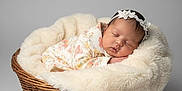 Zhanna is registered to the contest to win money with this photo: baby, basket, blanket, child, cozy, cute, floral_clothing, gray_background, headband, infant, newborn, peaceful, portrait, resting, sleeping, soft_texture, studio, toddler, wicker, wrapped