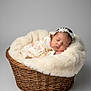 Zhanna is registered to the contest to win money with this photo: baby, basket, blanket, child, cozy, cute, floral_clothing, gray_background, headband, infant, newborn, peaceful, portrait, resting, sleeping, soft_texture, studio, toddler, wicker, wrapped