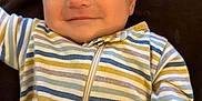 Ames is registered to the contest to win money with this photo: baby, infant, smile, closed_eyes, striped_clothing, onesie, sleeping, child, cute, peaceful, resting, portrait, young_child, soft_lighting, indoors, human, small_person, adorable, face, relaxation