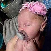 Sina is registered to the contest to win money with this photo: arm, baby, blanket, child, closeup, comfort, cozy, hand, headband, indoors, infant, newborn, pacifier, person, pink, skin, sleeping, soft, tattoo, tattoo_star