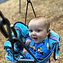 baby, child, swing, playground, blanket, blue_clothing, infant, happy, smiling, outdoor, metal_chain, seat, cute, face, fun, park, young_child, play, person, seat_belt