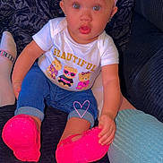 Zoey is registered to the contest to win money with this photo: baby, child, infant, portrait, sitting, couch, bow, pink, shoes, sparkly_shoes, jeans, shirt, bear_design, smiling, wide_eyed, indoor, furniture, closeup, fashion, colorful